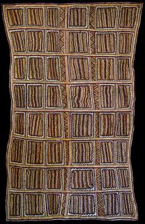 Australian Indigenous (Aboriginal and Torres Strait Islander) artwork by LILA WARRIMOU (MISASO) of Omie Artists. The title is Design of the ceremonial shell necklace, pig hoof-prints in the garden, beaks of the Papuan Hornbill and spots of the wood-boring grub. [18-016] (Natural Pigments on Nioge (Woman’s Barkcloth Skirt)