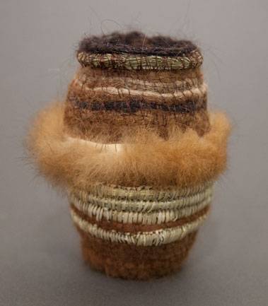 Australian Indigenous (Aboriginal and Torres Strait Islander) artwork by GILLIAN GARVIE of Baluk Artists. The title is Passing Down Knowledge. [117-18] (Found Materials and Fibres)