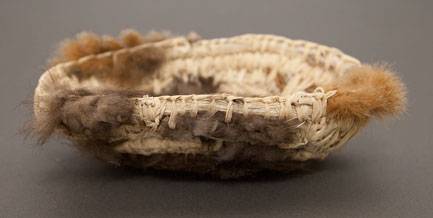 Australian Indigenous (Aboriginal and Torres Strait Islander) artwork by CASSIE LEATHAM of Baluk Artists. The title is Weaved Coolamon with Possum Fur. [122-18] (Found Materials and Fibres)