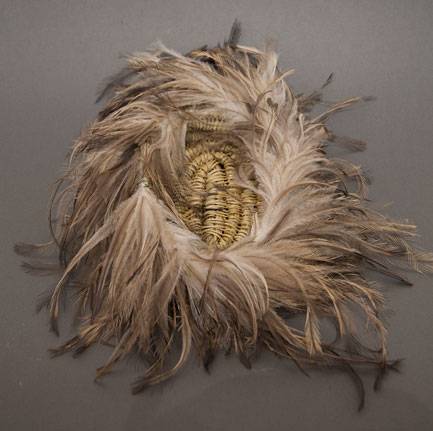 Australian Indigenous (Aboriginal and Torres Strait Islander) artwork by CASSIE LEATHAM of Baluk Artists. The title is Woven Coolomon with Emu Feather. [134-18] (Found Materials and Fibres)